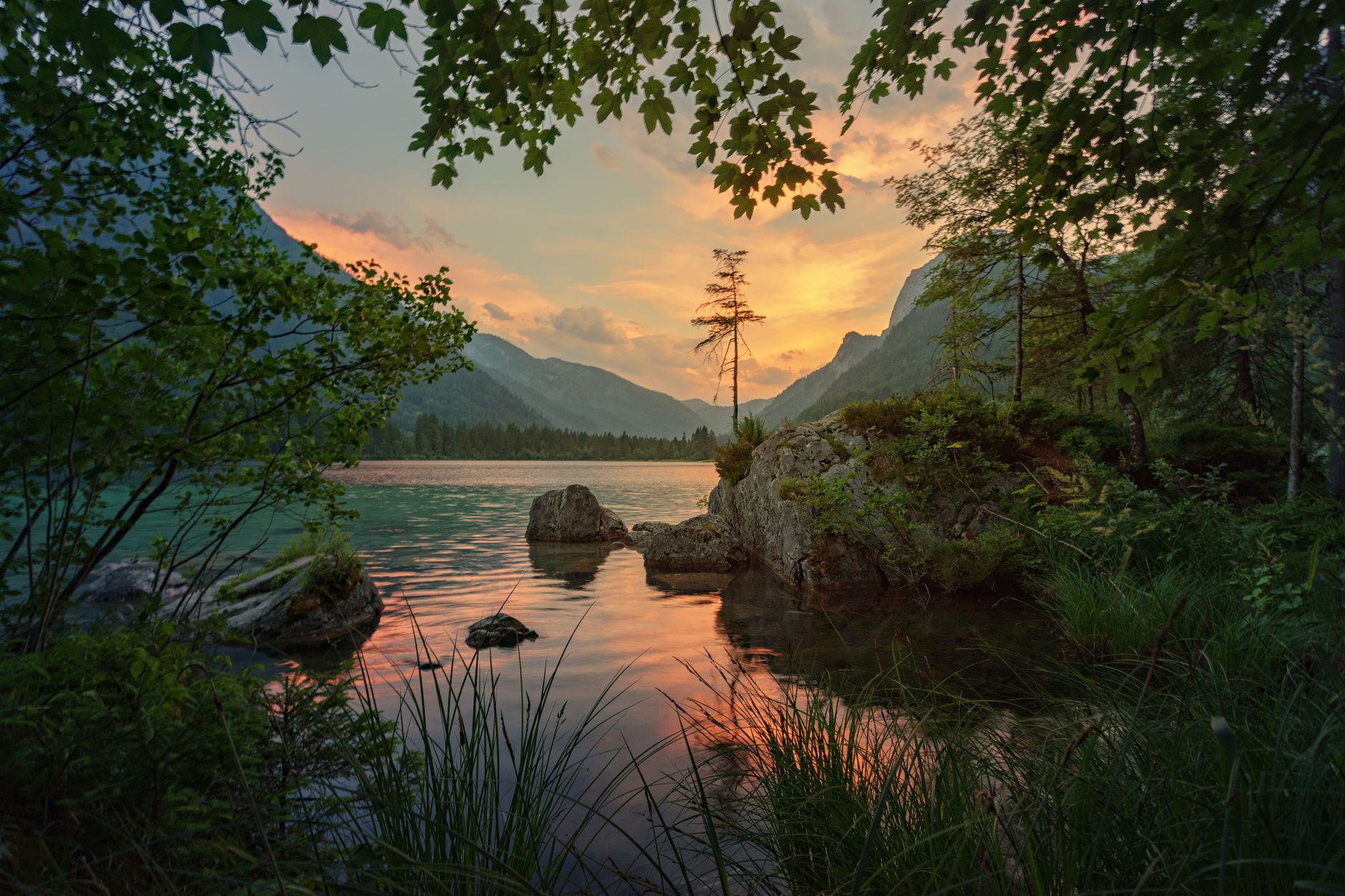 Travel photographer looking at mountain lake